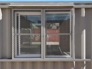 Barn door window security for storage container for sale
