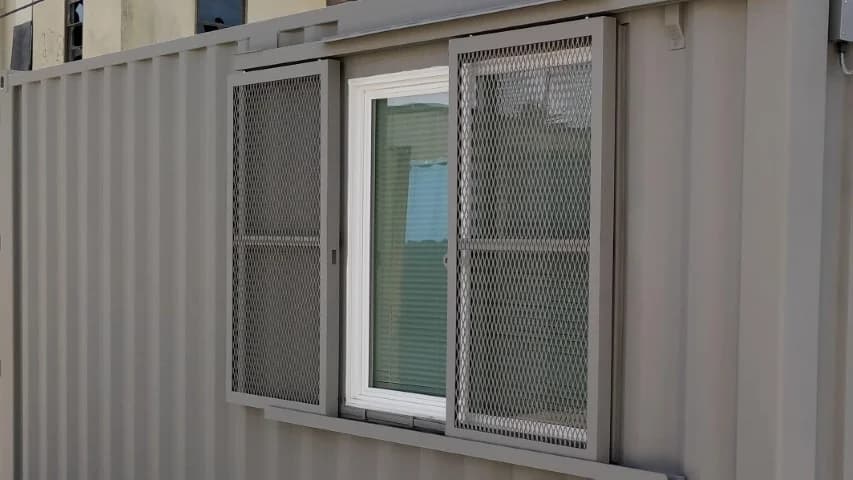 Barn door window security for storage container for sale