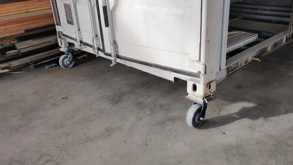 Shipping container caster wheel