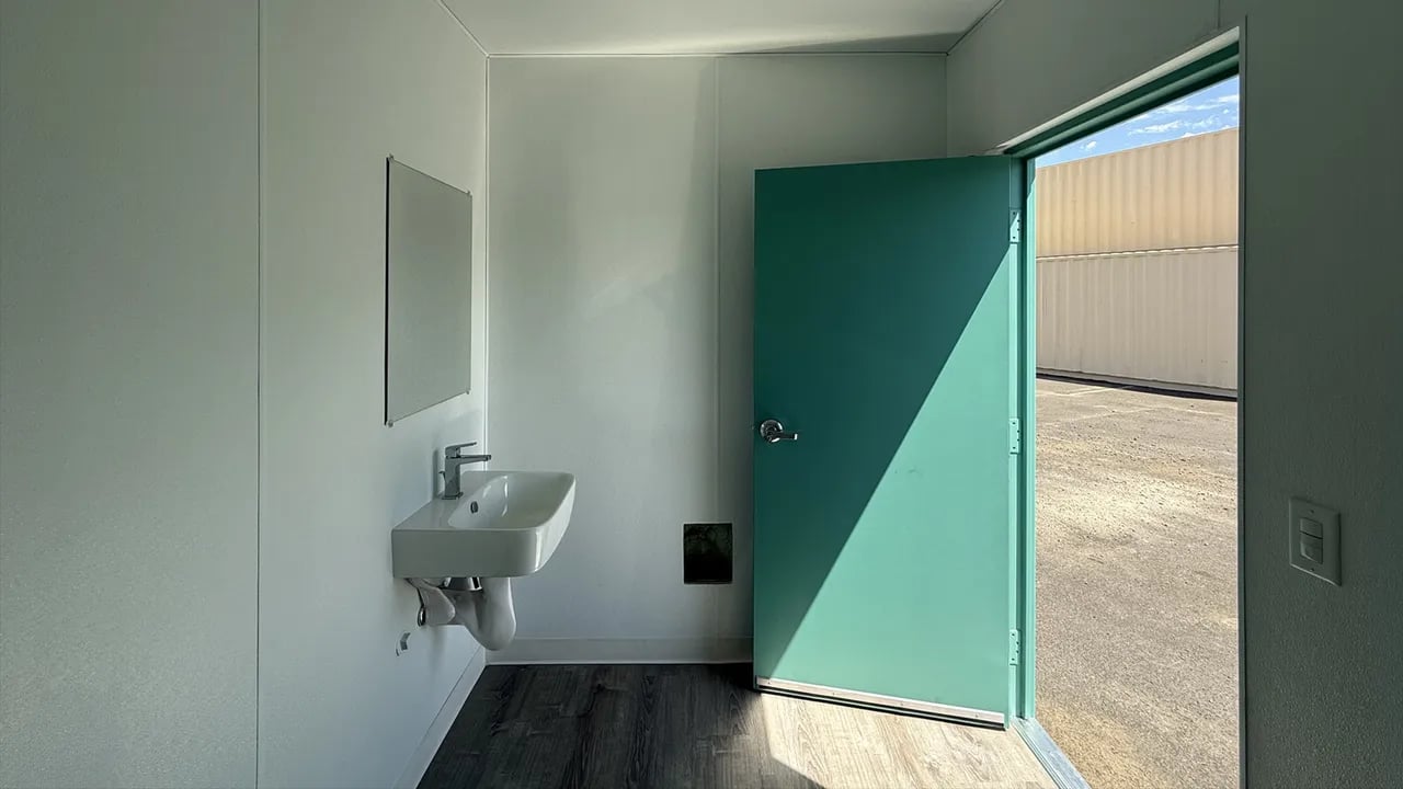 Blue 20ft container with restroom inside