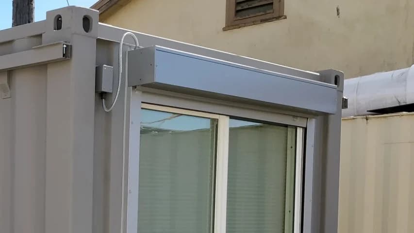Electric window shutter installed on a container