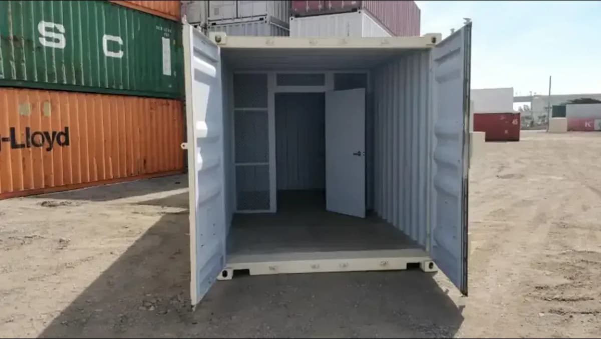 Steel partition wall inside a shipping container office with storage