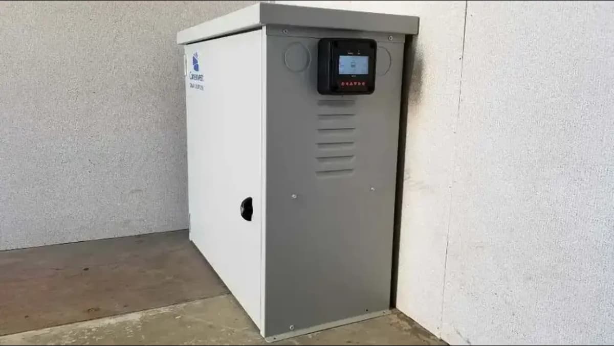 A gray solar power control unit mounted on the side of a wall.