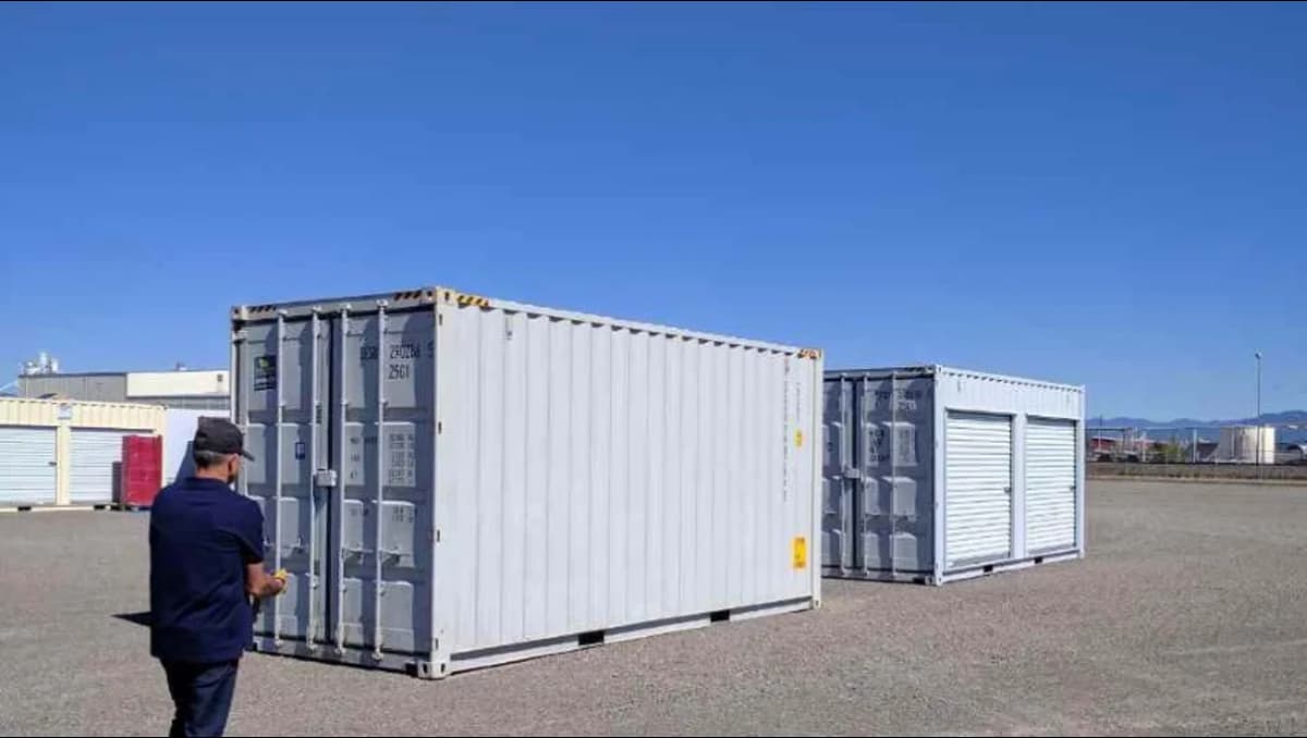 A man moving towards Conexwest’s shipping container inventory.
