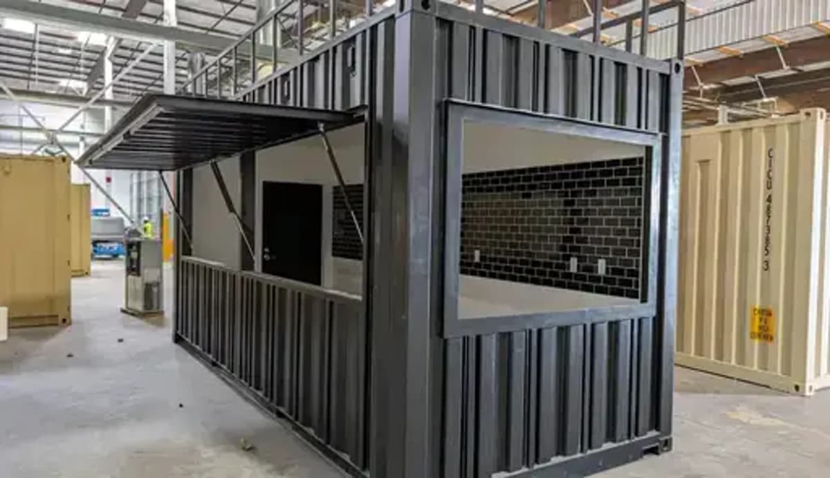 A shipping container with an awning.