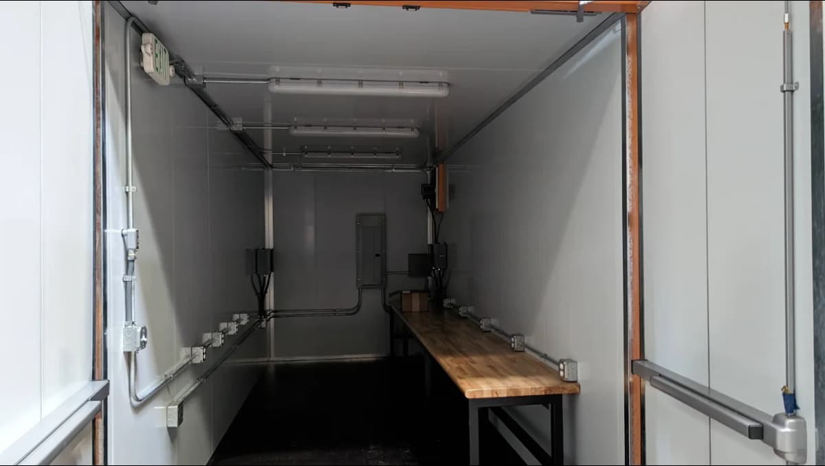 An interior of a shipping container office.