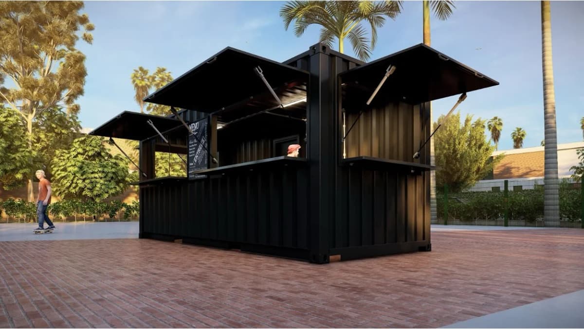 Black shipping container cafe with multiple fold-up service windows outdoors