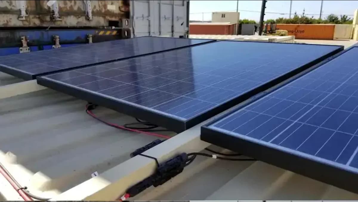 Close-up view of solar panels installed on the roof of a shipping container.