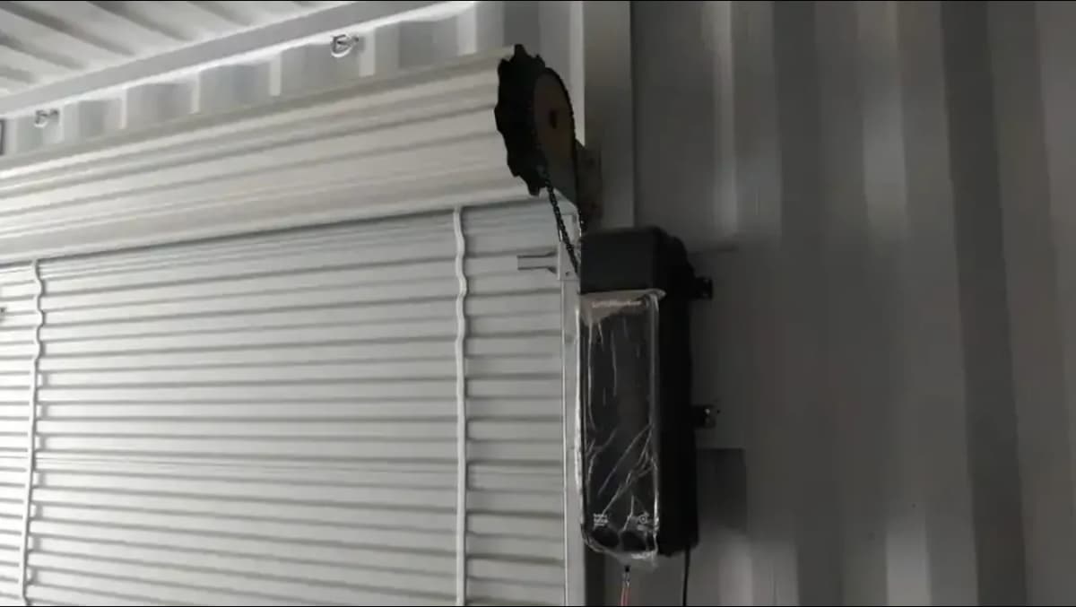 Powered roll-up door add-on for shipping containers.