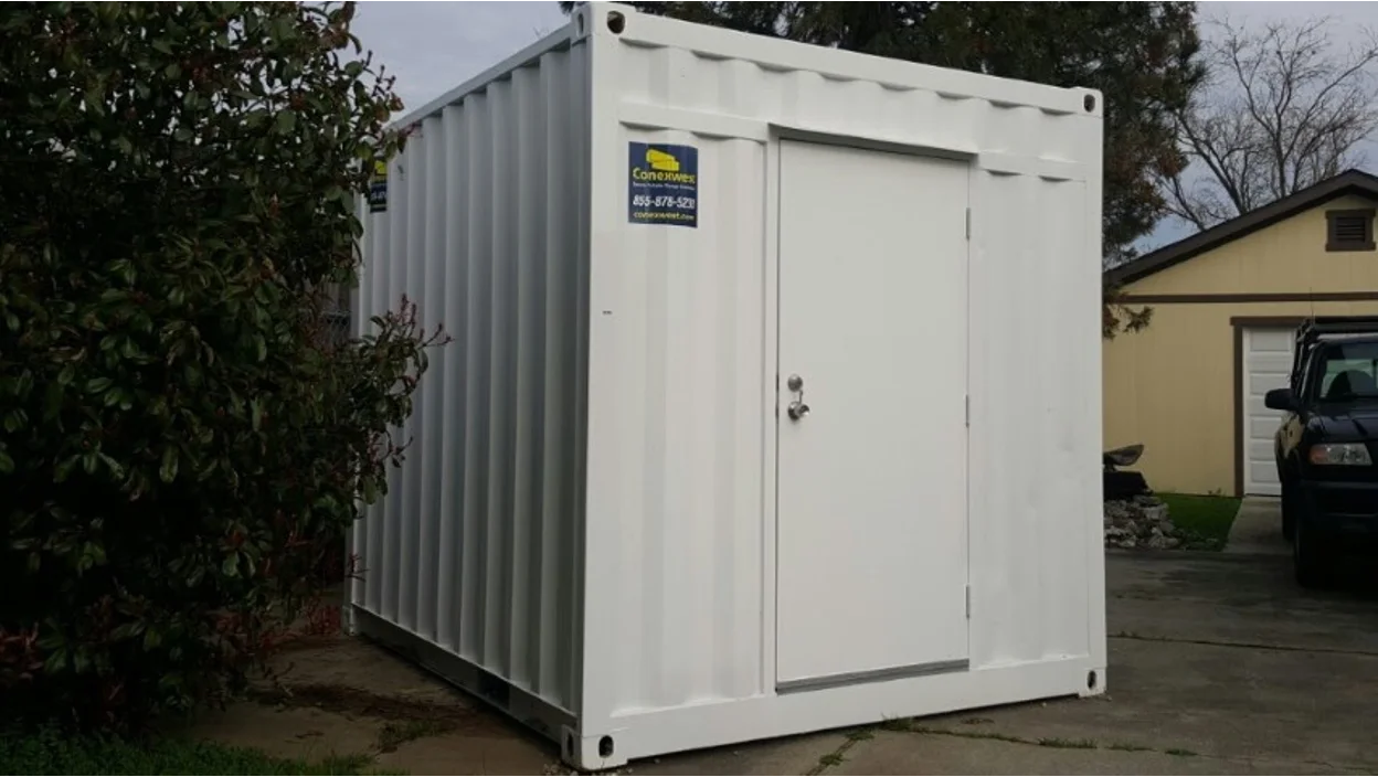 A Conexwest shipping container with a man door.