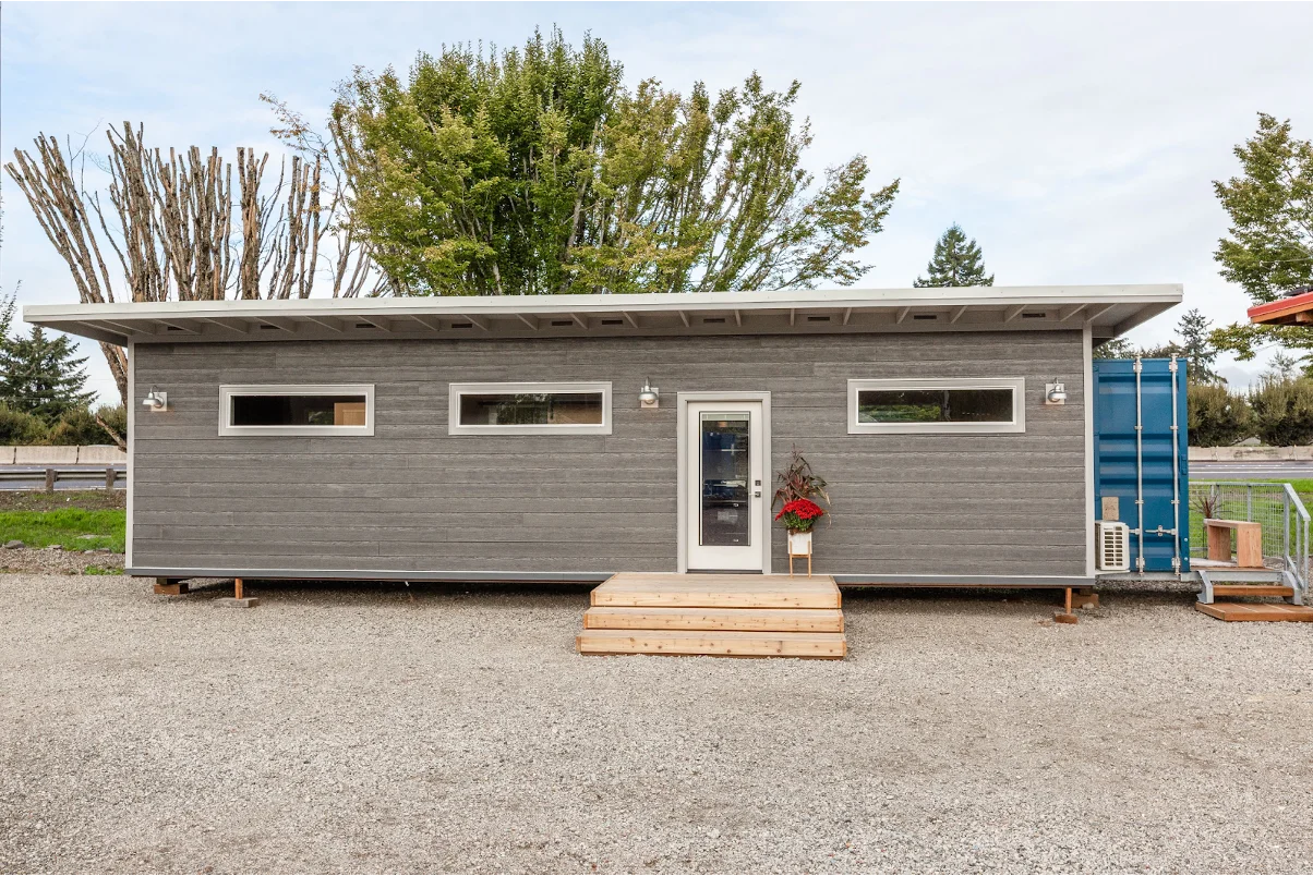 A shipping container with siding.