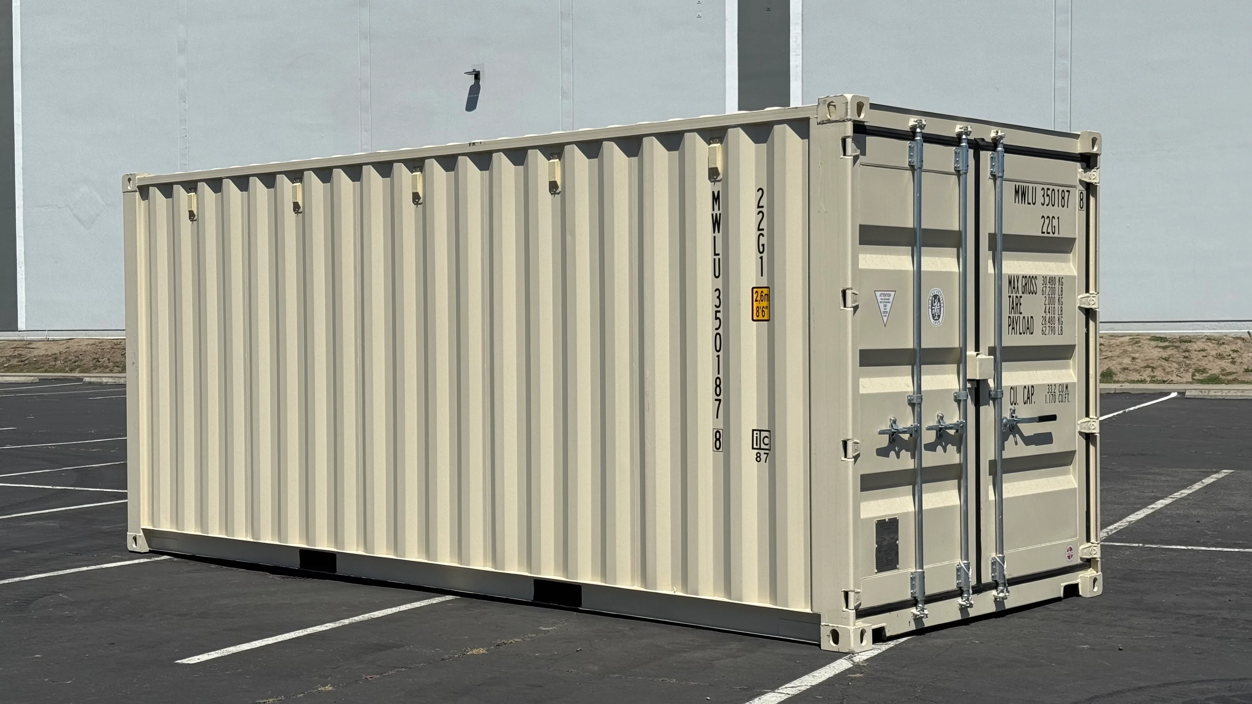 New one-trip shipping container in clean condition with cargo doors, corrugated steel walls, and minimal wear in a container yard.