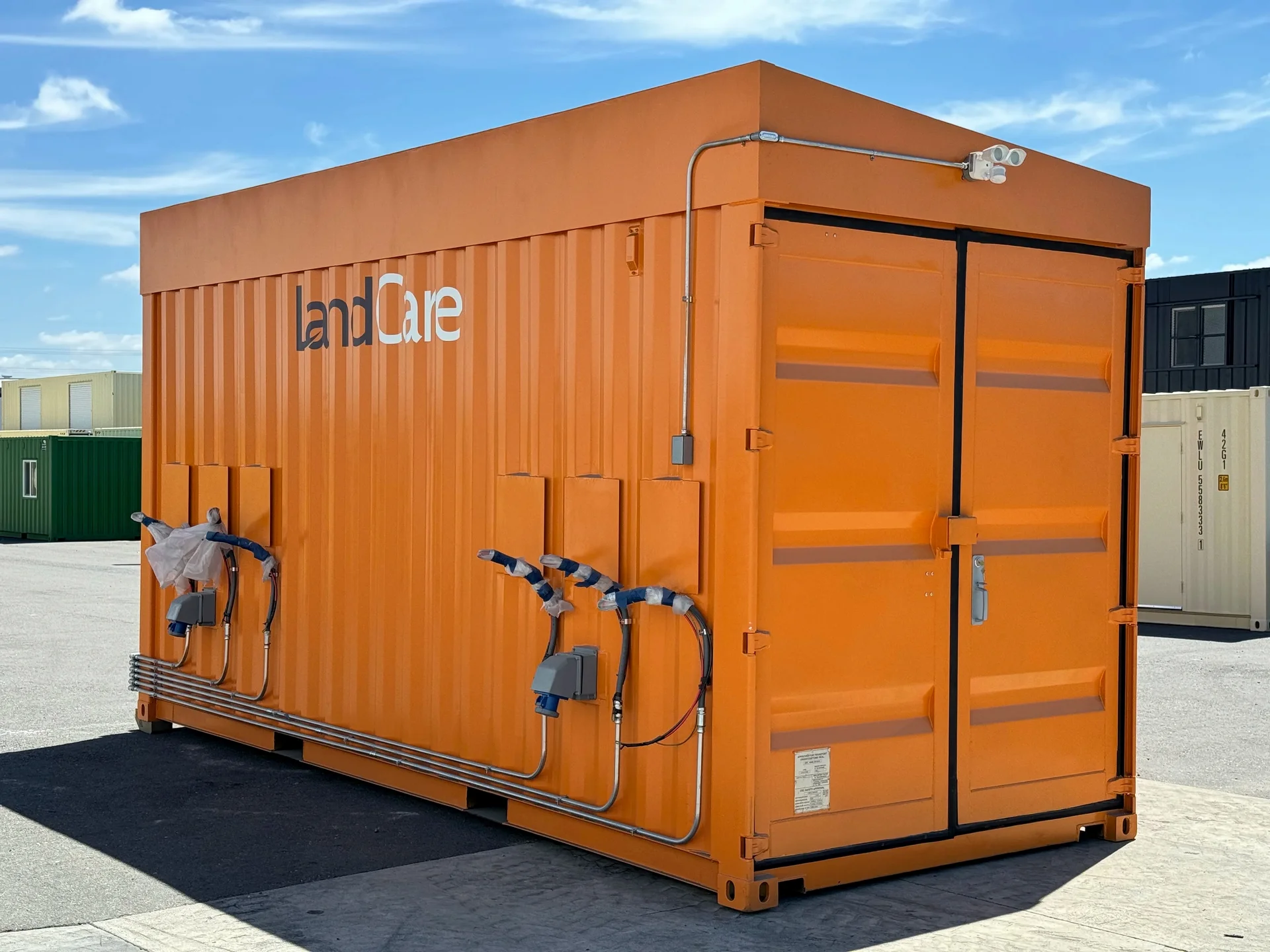 Photo of an orange-painted modified shipping container unit